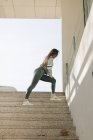Девушка в спортивной одежде тренируется на улице — стоковое фото