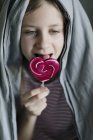 Girl eating sweet lollipop at home, selective focus — Stock Photo