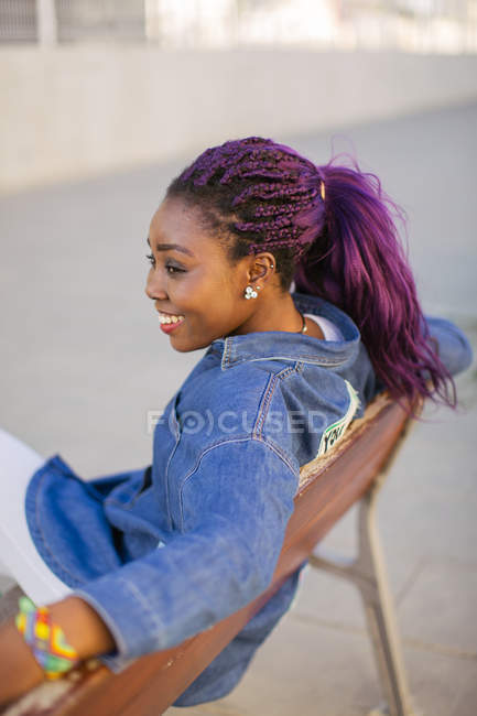 Африканський жінка, сидячи на лавці міста — стокове фото