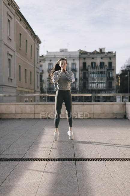 Young woman in sportswear training at street — Stock Photo