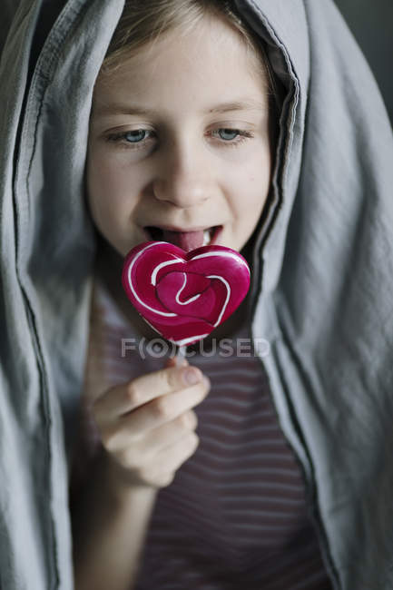 Girl eating sweet lollipop at home, selective focus — Stock Photo