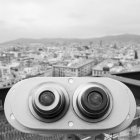 Tourist binoculars overlooking city — Stock Photo
