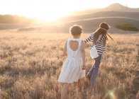 Two girls walking outdoors — Stock Photo