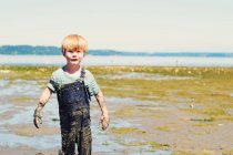 Boy covered in mud — Stock Photo