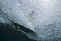 Surfing board view from underwater — Stock Photo