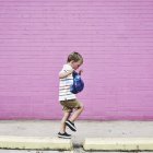 Маленький хлопчик, що йде на тротуарі — стокове фото
