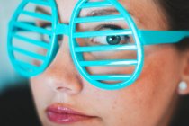 Woman wearing novelty slotted glasses — Stock Photo