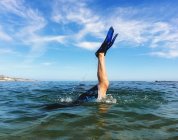 Beine tauchen ins Meerwasser — Stockfoto