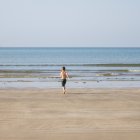 Menino correndo para o mar — Fotografia de Stock