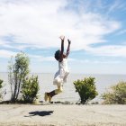 Chica saltando en la playa - foto de stock