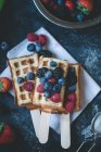 Berries and waffles on sticks — Stock Photo