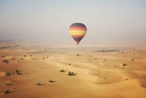 Hot air balloon over the desert — Stock Photo