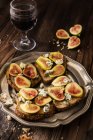 Toasts on tray with glass of red wine — Stock Photo