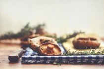 Mushrooms and rosemary on table — Stock Photo