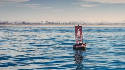 Red buoy on water — Stock Photo