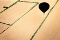 Air balloon shadow in fields — Stock Photo