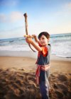Boy playing with makeshift bow and arrow — Stock Photo