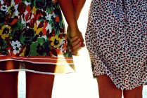 Female friends holding hands — Stock Photo