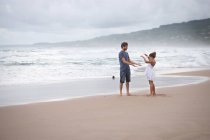 Отец и дочь играют на пляже — стоковое фото