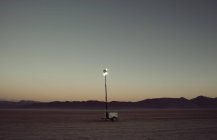 Lamp in middle of desert — Stock Photo