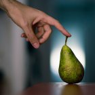 Spain, Man touching pear — Stock Photo