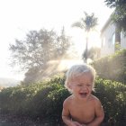 Toddler laughing in garden — Stock Photo