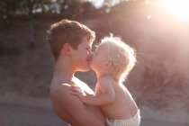 Brothers kissing each other — Stock Photo