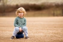 Boy with ball in field — Stock Photo