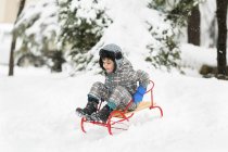 Boy riding sledge — Stock Photo