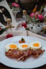 Eggs with bacon on plate — Stock Photo
