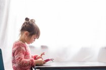 Girl playing with digital tablet — Stock Photo