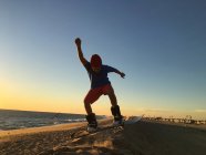 Boy sandboarding on beach — Stock Photo
