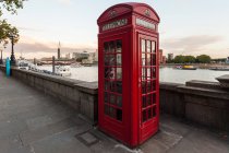 Red telephone box on quay — Stock Photo