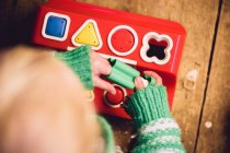Baby girl playing with shape board — Stock Photo
