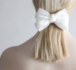 Woman wearing white bow — Stock Photo