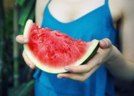 Woman holding slice of watermelon — Stock Photo