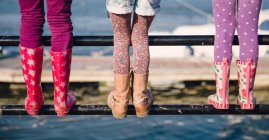Girls standing on railing — Stock Photo