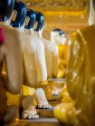 Statues of Buddha and disciples praying — Stock Photo