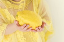 Girl holding lemon — Stock Photo