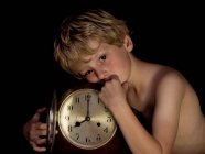 Boy with antique clock — Stock Photo