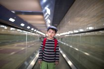 Boy standing on escalator — Stock Photo