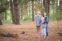 Three boys looking up in forest — Stock Photo