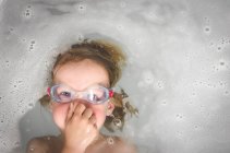 Junge mit Brille spielt in Badewanne — Stockfoto