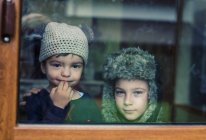 Boys looking out of window — Stock Photo