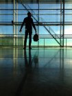 Man standing next to window at airport — Stock Photo