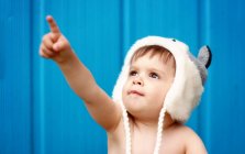 Portrait of boy pointing at sky — Stock Photo