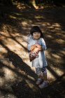 Girl holding bag with chestnuts — Stock Photo