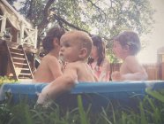 Children bathed and play in paddling pool — Stock Photo
