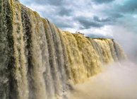 Powerful stream waterfall on border — Stock Photo