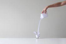 Hand einer Frau, die Milch gießt — Stockfoto